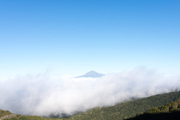 Pico de Teide, the highest mountain in Spain on the Island Tenerife. Huge clouds from trade winds over the national park Garajonay on La Gomera. The clouds comes from the Azores in circa 800m altitude