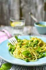 Spaghetti with green peas and basil pesto.