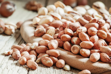 Peeled raw peanuts, nut mix, healthy eating, selective focus
