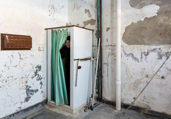 Abandoned shower and man inside Trans-Allegheny Lunatic Asylum