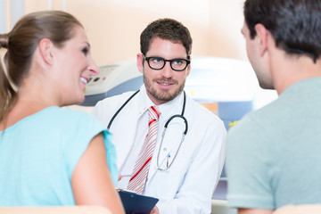 Pregnant woman and her partner seeing physician