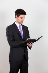 Business man is writing on a notepad