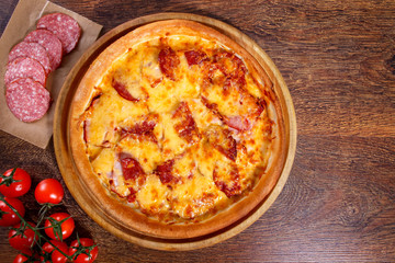 Pizza with salami, pastrami, ham and cheese