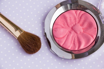 Powder Make Up Foundation Close Up With Detail and brush on a purple background, soft color...