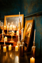 Many burning candles on a mirrored background