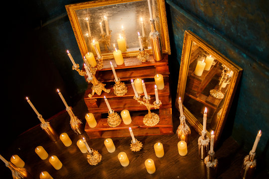 Many burning candles on a mirrored background