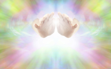 Life Force Healing Energy - female hands emerging from vibrant rainbow colored energy field with white light beneath and plenty of copy space
