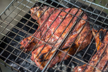 Pork steaks and grill on the burning fire