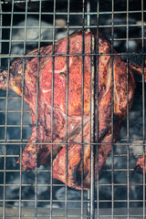 Pork steaks and grill on the burning fire