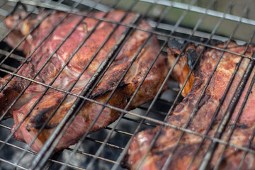 Pork steaks and grill on the burning fire