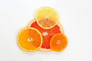sliced lemon, mandarin, grapefruit and orange on a white backgro