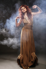 Fototapeta premium young woman in beige long dress