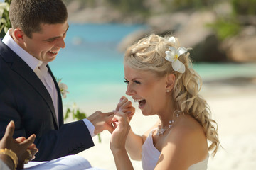 Couple exchanging rings during wedding registry ceremony on trop