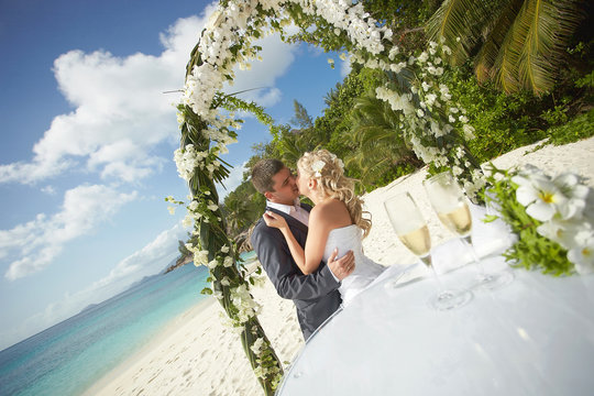 Beautiful, gorgeous, young wedding couple kissing during ceremon