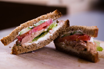 Fresh homemade grilled tuna sandwich on wooden background