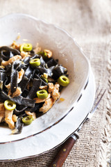 Black pasta with chicken and green olives tasty