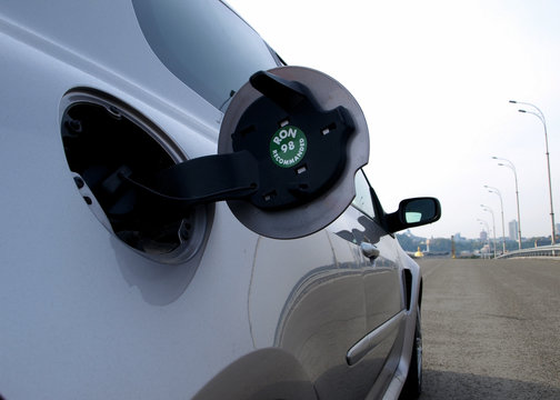 Open fuel flap of sport car with recomended octane number 