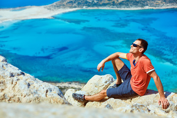 man reluxing on the rock