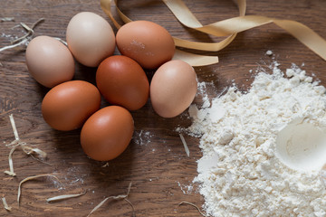 Eggs and flour on a wooden board