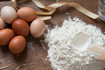Eggs and flour on a wooden board