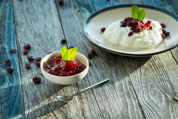 Plate with fresh yogurt on wooden table