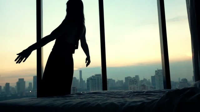 Pretty woman falling on bed at home, super slow motion 240fps

