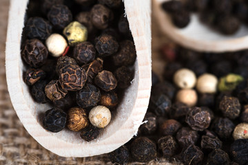 Wooden scoop with dried pepper berries