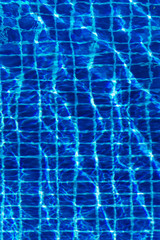 Water surface background in blue swimming pool outdoors