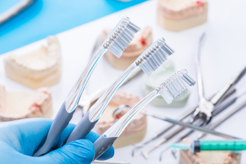 Teeth mold and basic dental tools on white table