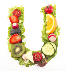 Letter U made of salad and fruits
