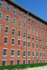 close up on old brick wall building and green lawn