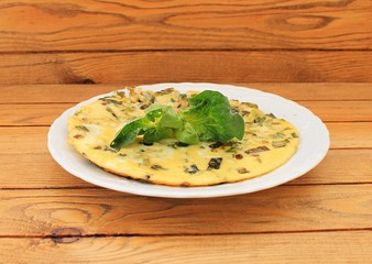 Omelet with spinach cooked in olive oil