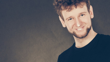 Smiling man with cream on his face.