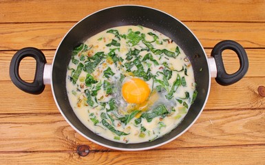 Omelet with spinach cooked in olive oil