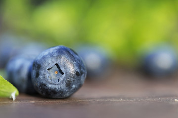 Fresh ripe blueberries outdoors on a wooden background