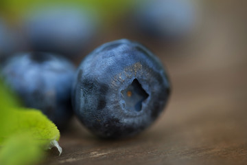 Fresh ripe blueberries outdoors on a wooden background