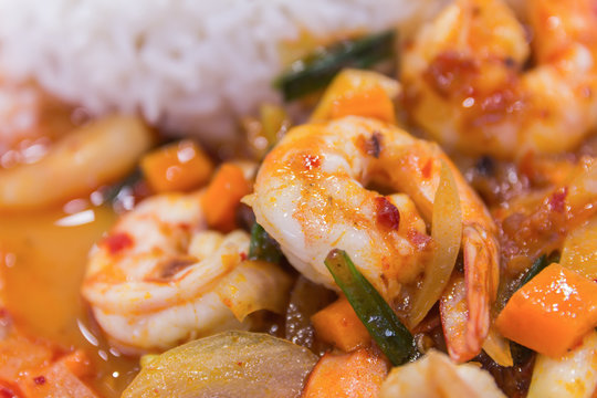 stir fried shrimp in thai red curry paste with rice and fried eg