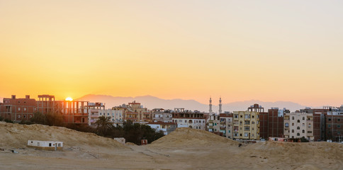 city on the edge of the desert during the evening twilight