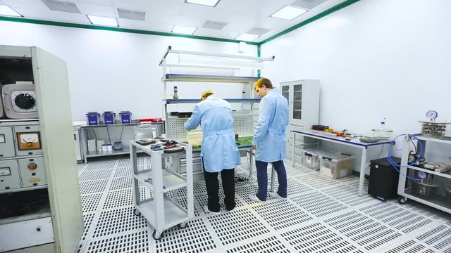 Two Engineers at the Tech Laboratory Testing Devices Instruments