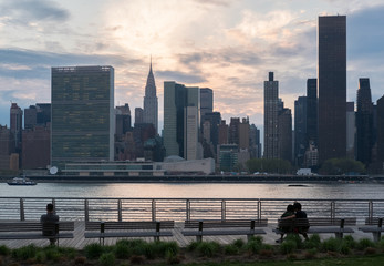 People enjoy the sunset over Manhattan - 109096289