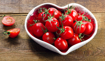 Fresh tomatoes in heart shaped plate.