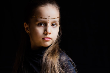 portrait of young girl at black background