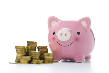 Pink piggy bank with gold coins