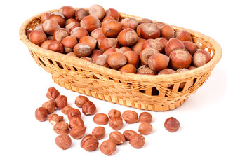 hazelnuts in a wicker basket isolated on white background