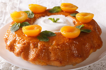 French dessert: Savarin with apricots and mint close-up. horizontal
