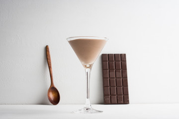 Chocolate mousse in martini glass on the wooden background