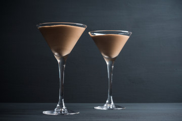 Chocolate mousse in martini glass on the wooden background