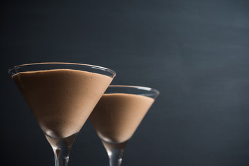 Chocolate mousse in martini glass on the wooden background