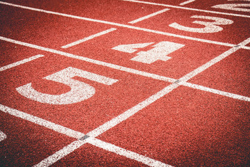 Fototapeta premium Numbers on rubber running track standard red color.