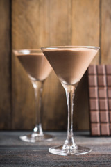 Chocolate mousse in martini glass on the wooden background